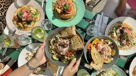Ein voller Tisch mit griechischen Gerichten wie Salat, Fava und Pita Briam im Pala Berlin in Prenzlauer Berg